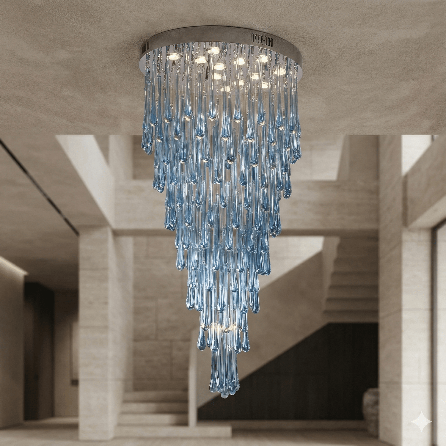 Large blue glass teardrop chandelier installed as a flush mount in a luxury entryway, dramatic cascading glass design with round canopy