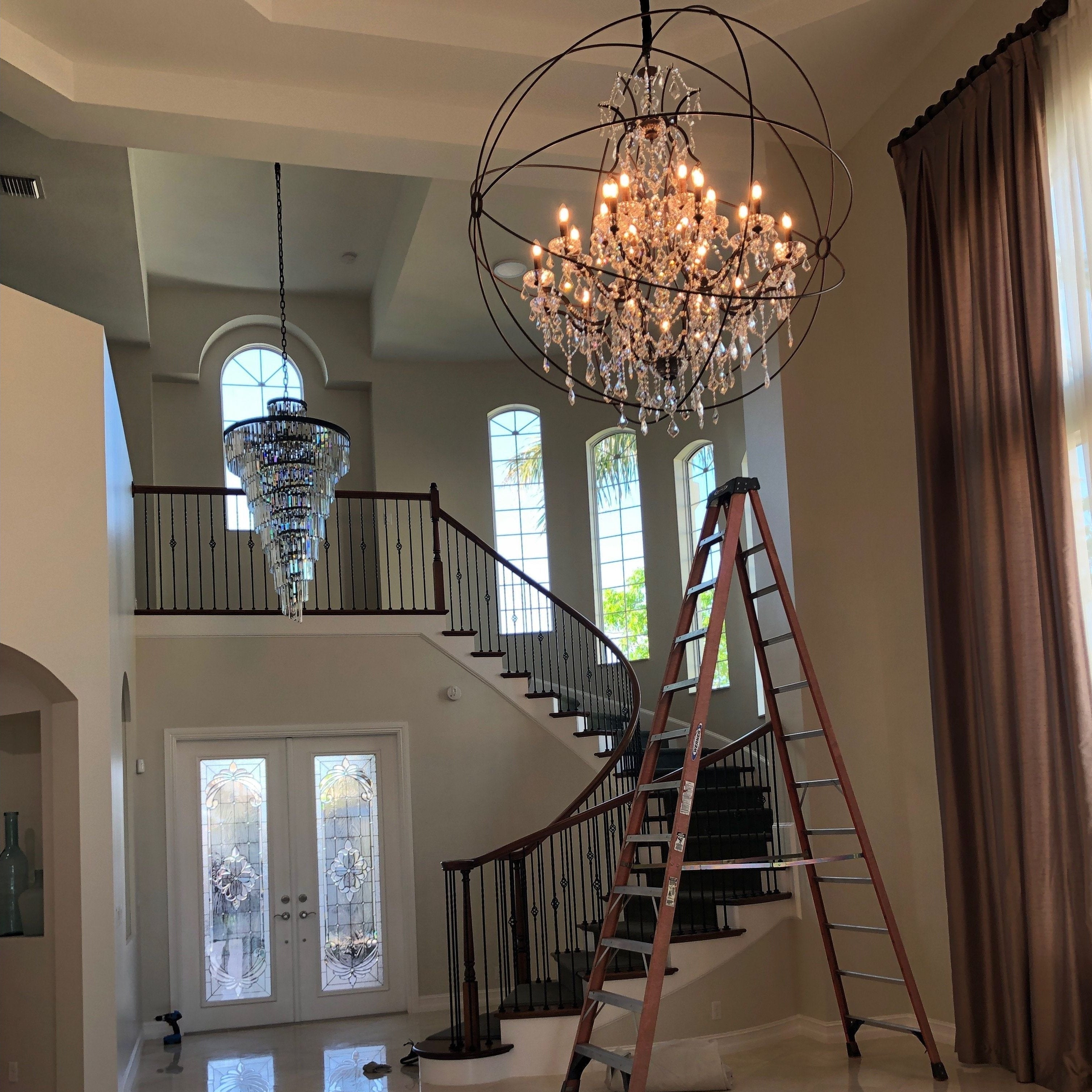 Veccini Odeon spiral tiered crystal fringe chandelier in matte black finish hanging in contemporary space